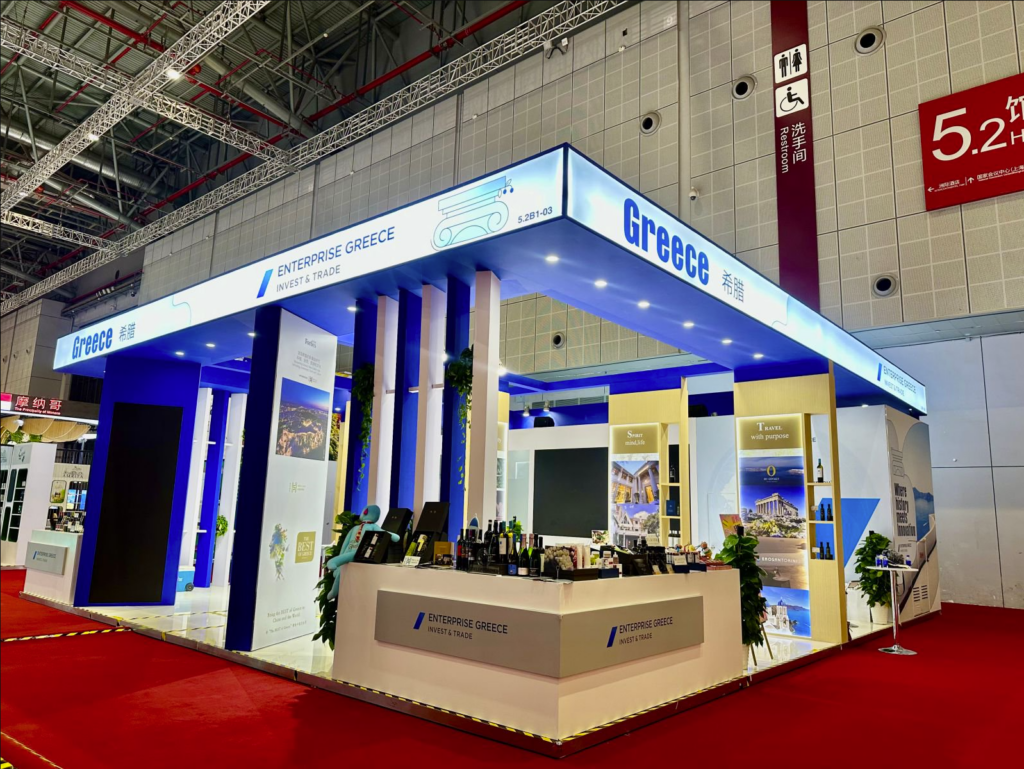 Greece Pavilion booth at the China International Import Expo (CIIE) featuring Enterprise Greece and “The Best of Greece” showcase with Greek wine, olive oil, and travel brands.